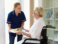 Volunteer delivering meal to a Senior Citizen at home